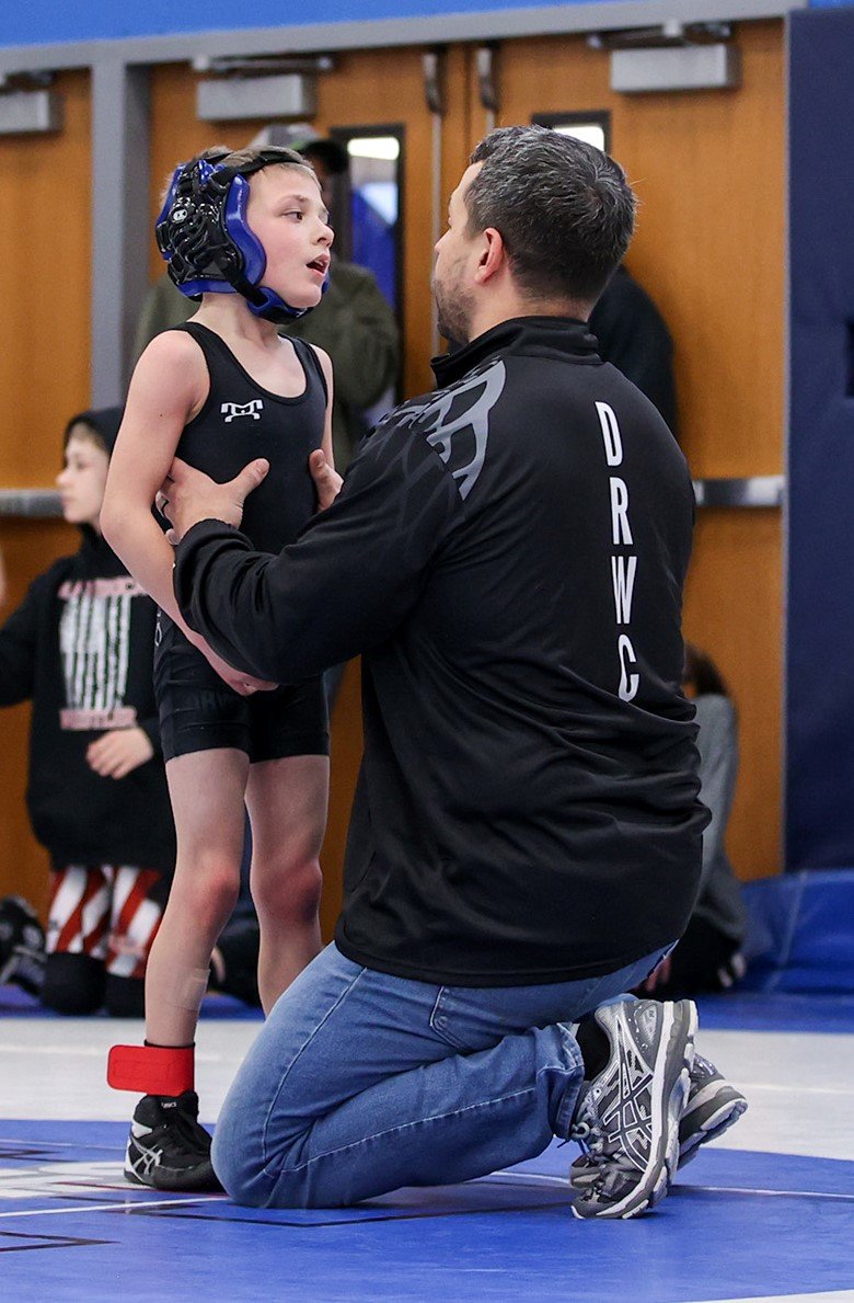 Deep Roots wrestling coach and owner Ricky Scott talks to Alex Rotolo during the Hudson Valley’s Premiere Youth Wrestling Tournament on March 4 at Valley Central High School.